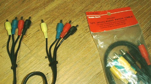 Photo, Cable has red, yellow, green, and black plugs on each end.