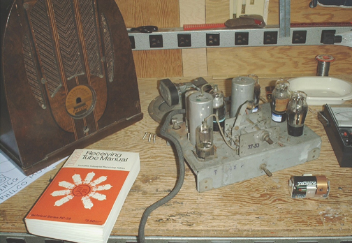  Philco of radio removed from cabinet with empty cabinet at left.