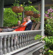 Generations lounge on the wide Victorian porch and visit