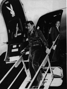 A younger Hugh Hefner disembarking his private 727 jet.
