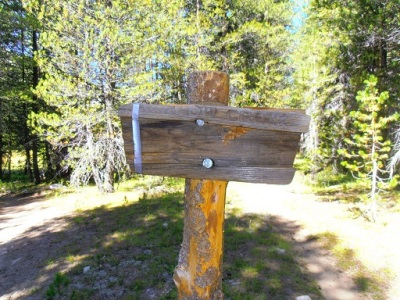 the trail sign is duck taped together