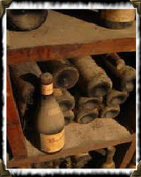 dusty shelf of wine bottles