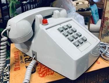 Vintage Grey Hotel Phone with a Red indicator Light on Top.