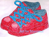 A child's red shoes with laces